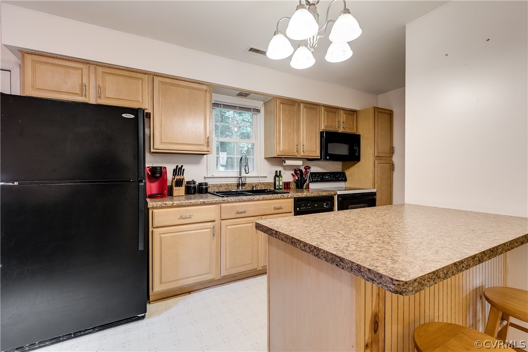 6531 Jessup Road Richmond, VA 23234 - Photo 9 of 29 a kitchen with a refrigerator and a sink