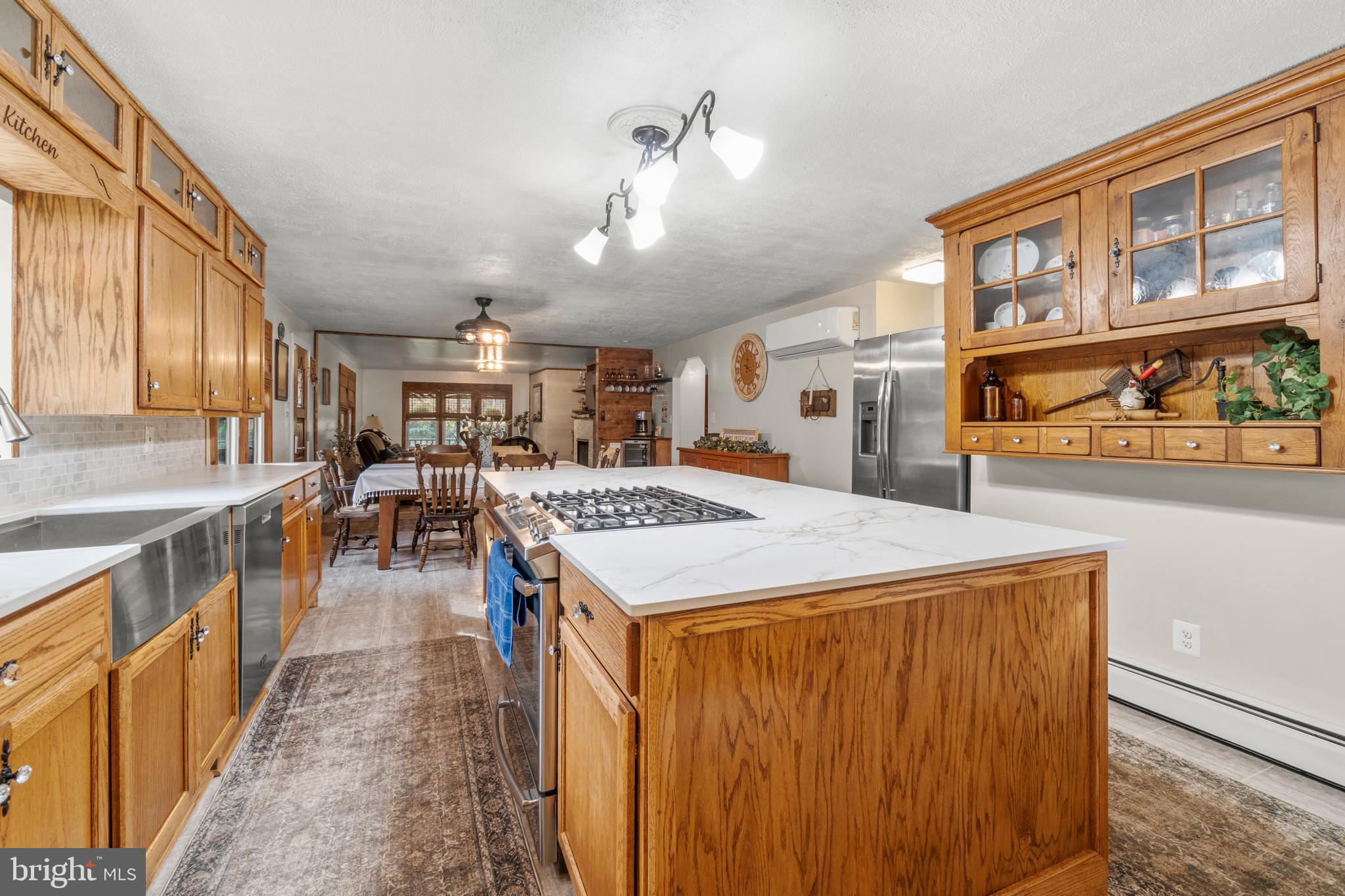 108 New Brooklyn Road Sicklerville, NJ 08081 - Photo 12 of 25 a large kitchen with stainless steel appliances granite countertop a stove a refrigerator a sink dishwasher with a dining table and chairs with wooden floor