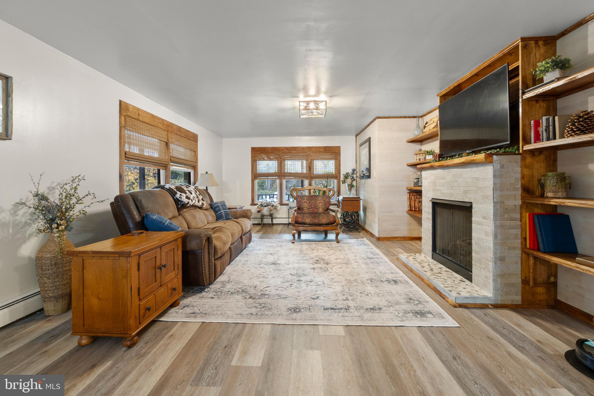 108 New Brooklyn Road Sicklerville, NJ 08081 - Photo 5 of 25 a living room with furniture a flat screen tv and a fireplace