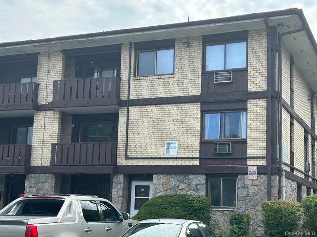 a front view of a house with parking space