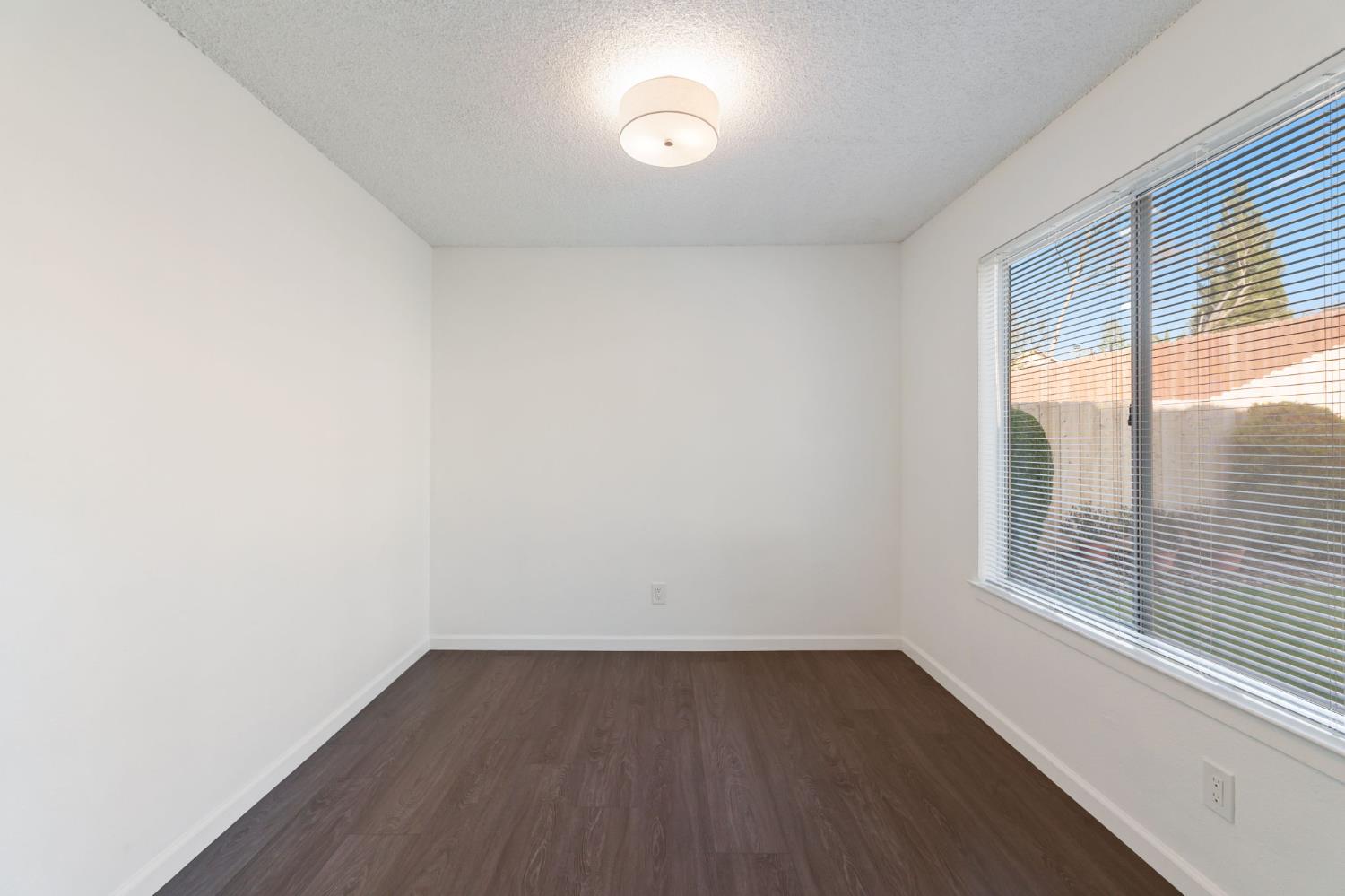 9342 North Archie Avenue Fresno, CA 93720 - Photo 14 of 36 a view of a room that has wooden floor and large window