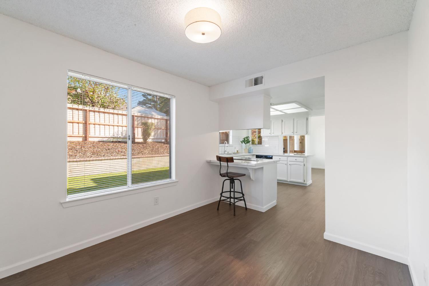 9342 North Archie Avenue Fresno, CA 93720 - Photo 15 of 36 a kitchen with a sink cabinets and wooden floor