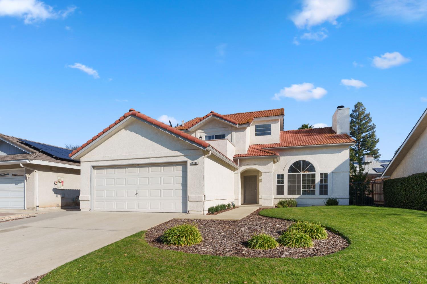 9342 North Archie Avenue Fresno, CA 93720 - Photo 2 of 36 a view of a yard in front of a house with a large tree
