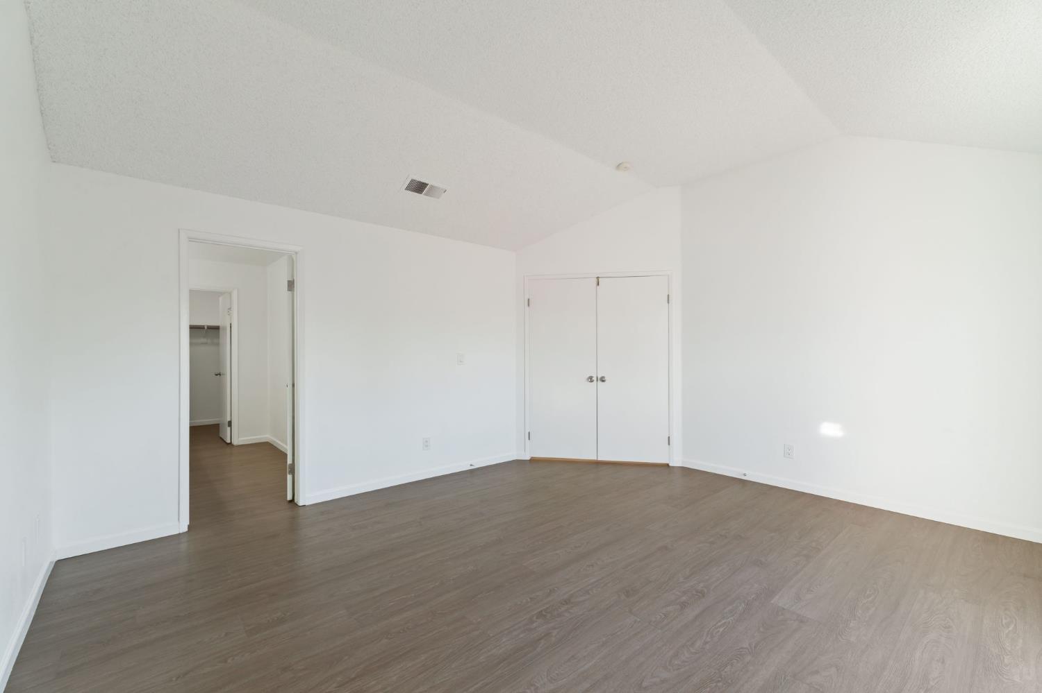 9342 North Archie Avenue Fresno, CA 93720 - Photo 26 of 36 a view of an empty room with wooden floor