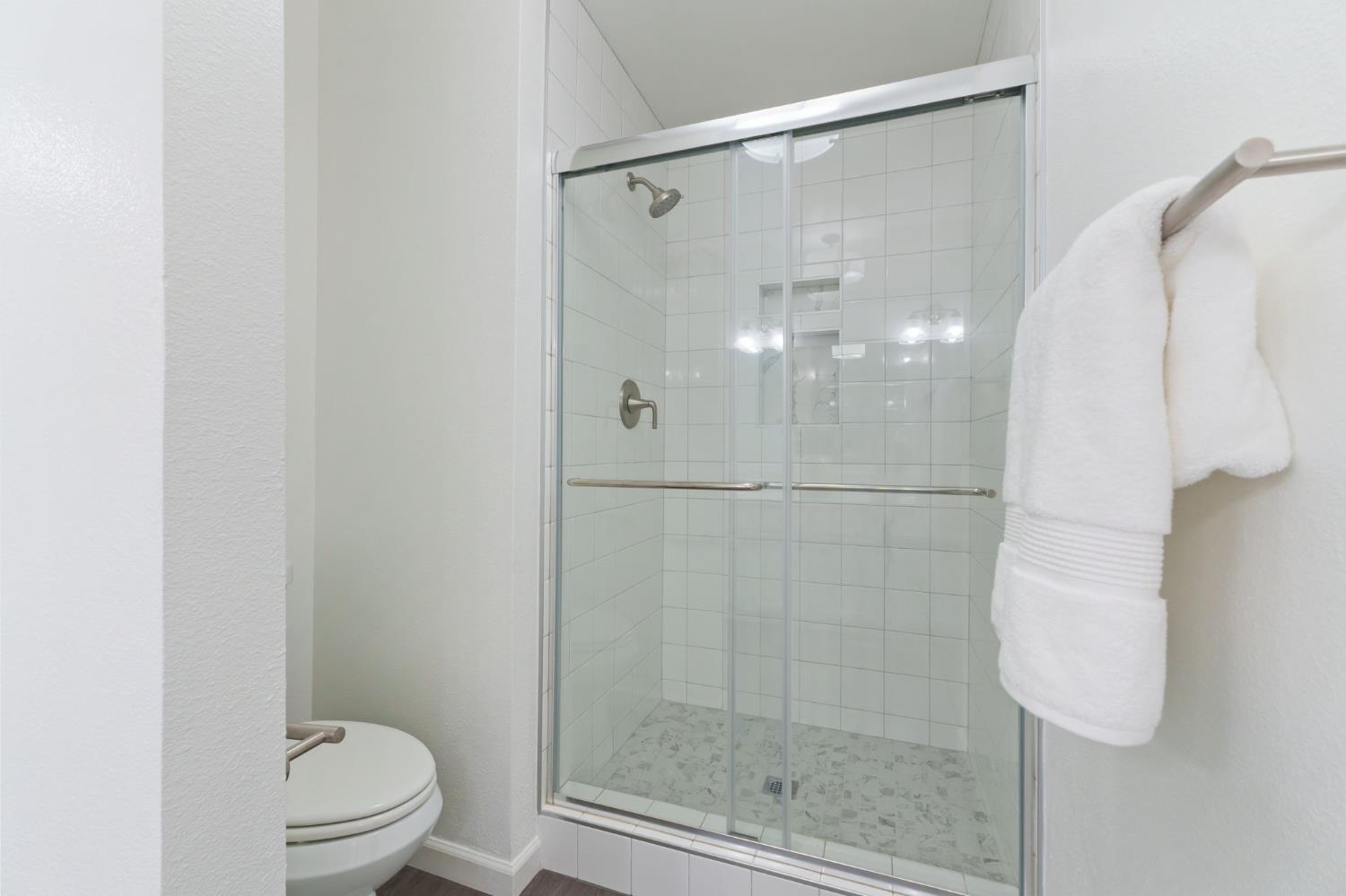 9342 North Archie Avenue Fresno, CA 93720 - Photo 28 of 36 a bathroom with a shower and toilet