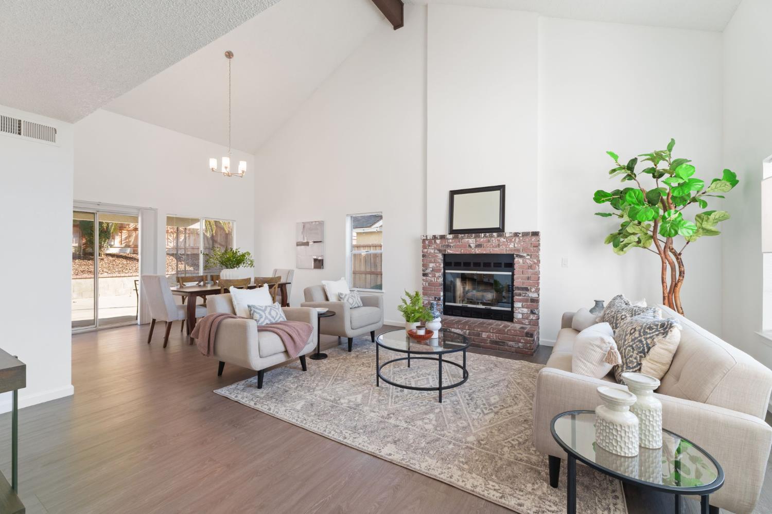 9342 North Archie Avenue Fresno, CA 93720 - Photo 5 of 36 a living room with furniture potted plant and a fireplace