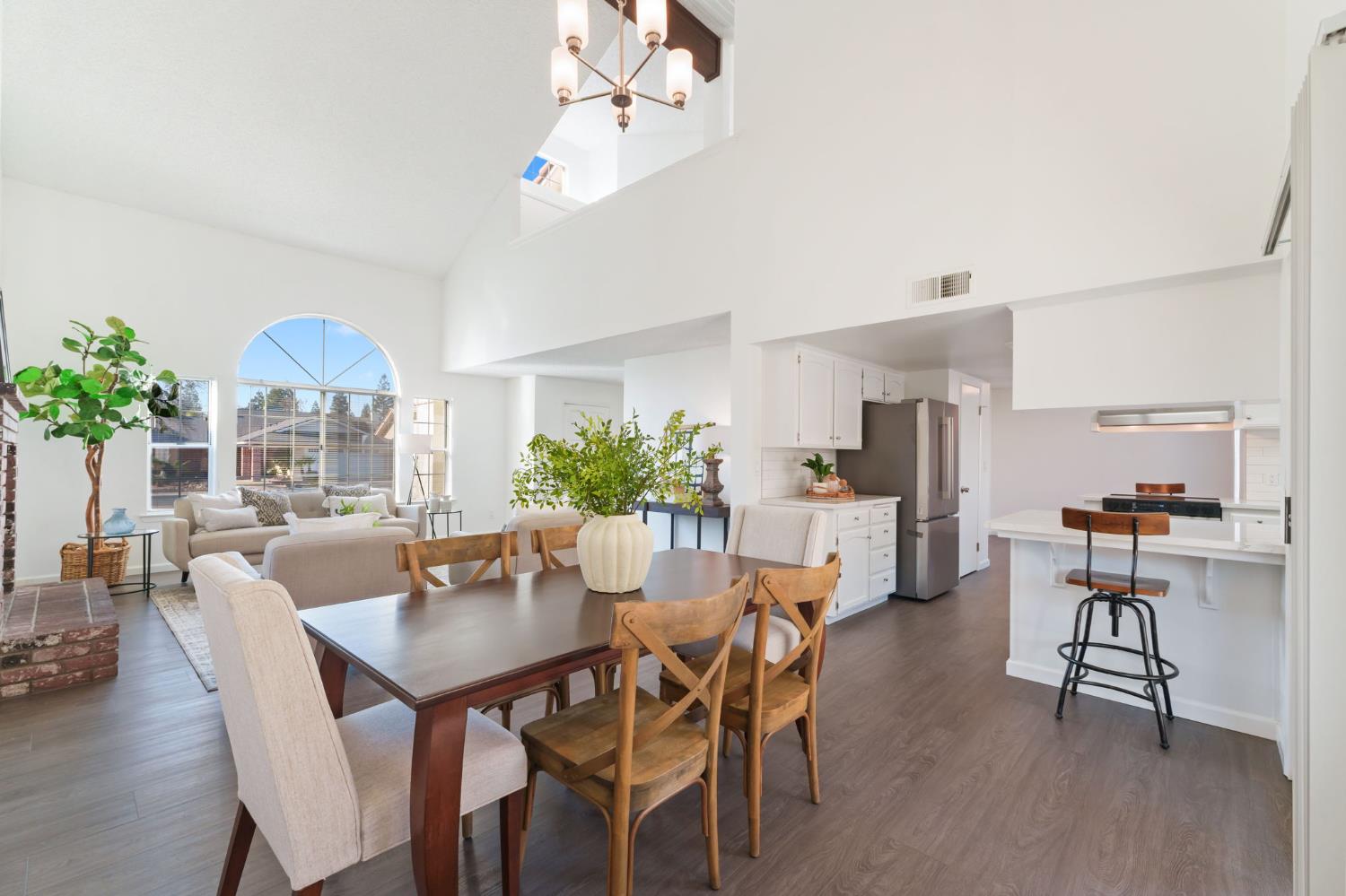 9342 North Archie Avenue Fresno, CA 93720 - Photo 9 of 36 a dining room with furniture potted plants and wooden floor