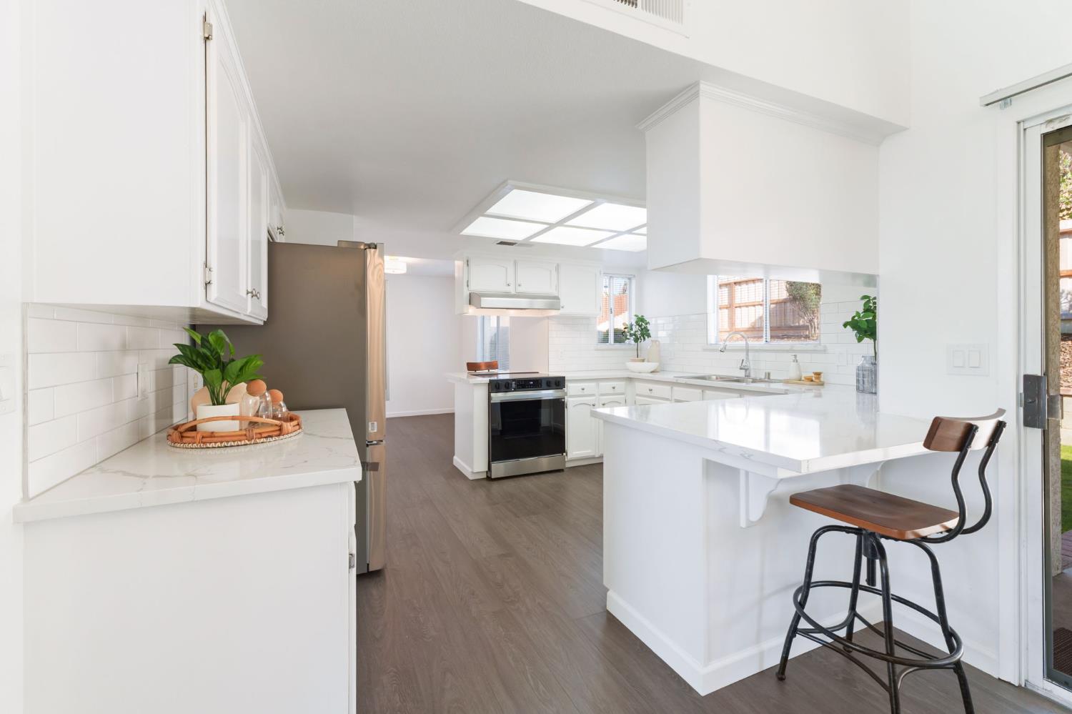 9342 North Archie Avenue Fresno, CA 93720 - Photo 10 of 36 a kitchen with a refrigerator and a stove top oven
