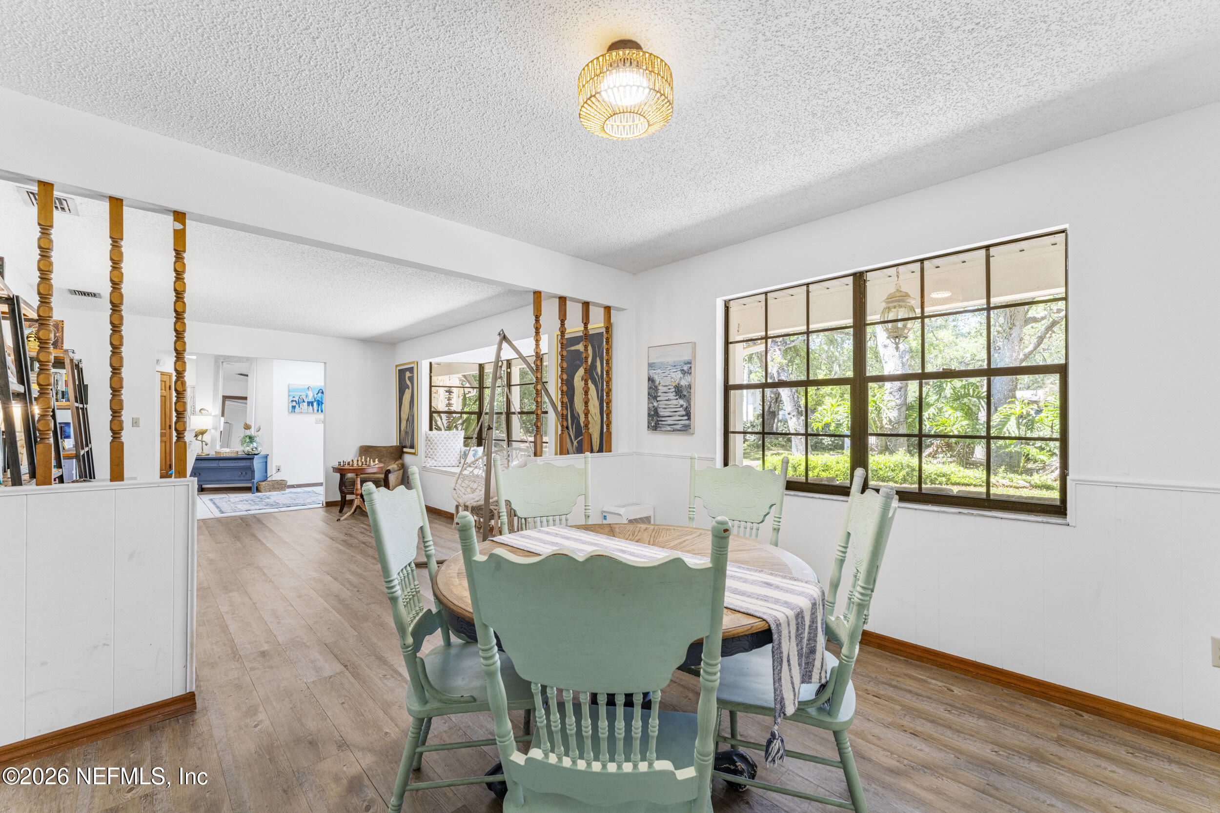 701 16th Street St. Augustine, FL 32080 - Photo 12 of 39 a view of a dining room with furniture a chandelier and wooden floor