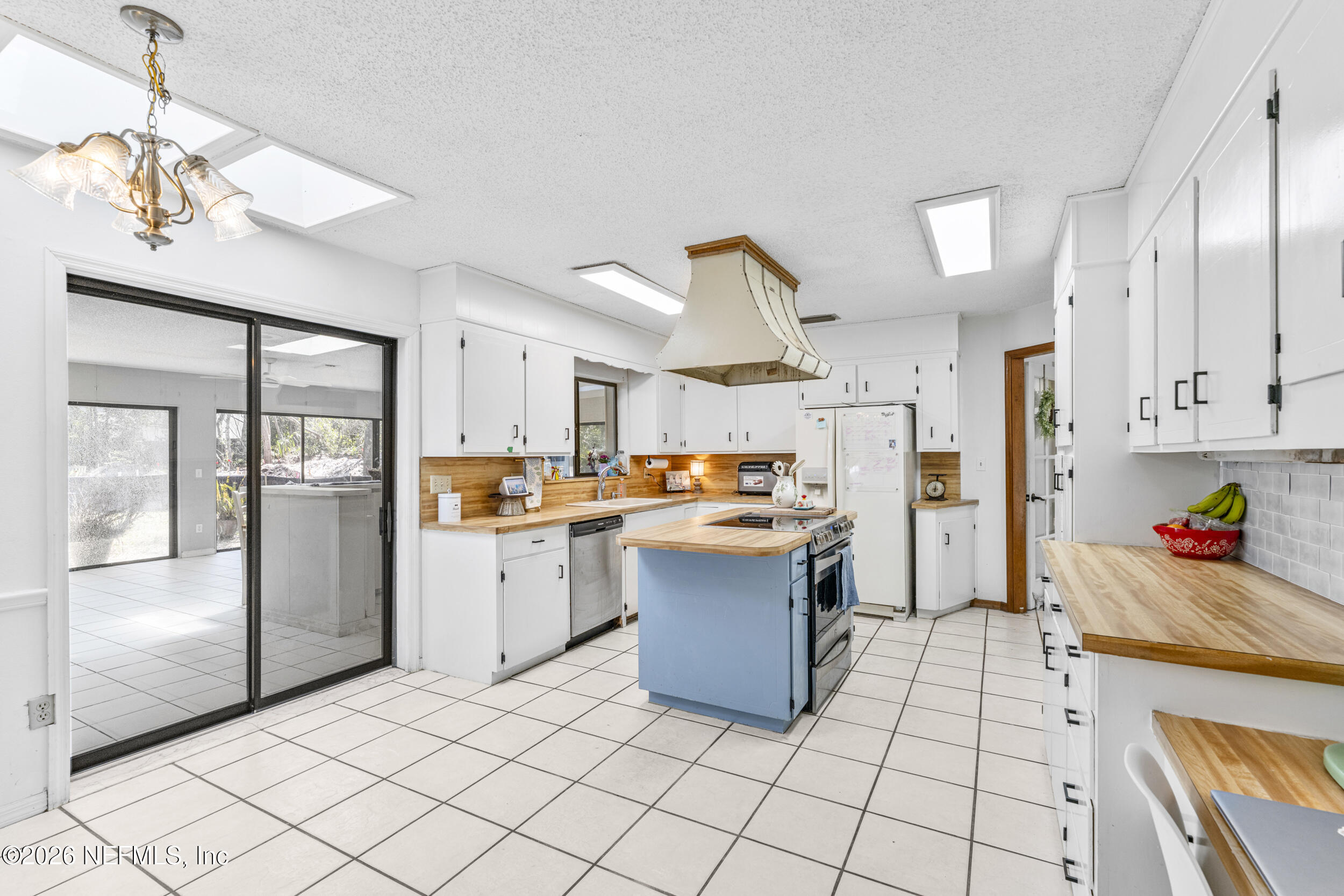 701 16th Street St. Augustine, FL 32080 - Photo 14 of 39 a kitchen with stainless steel appliances granite countertop a refrigerator and a sink