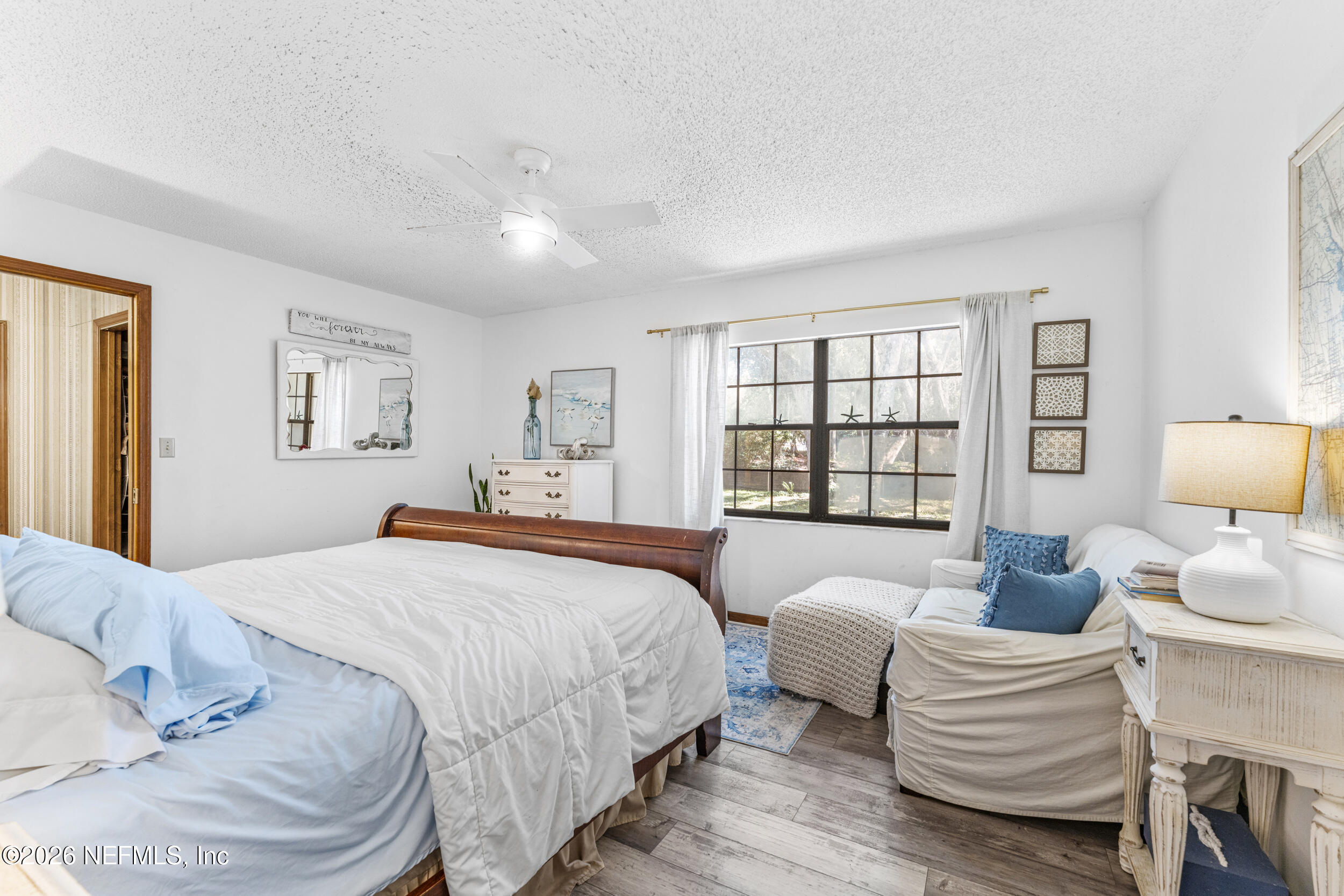 701 16th Street St. Augustine, FL 32080 - Photo 15 of 39 a bedroom with a bed and wooden floor