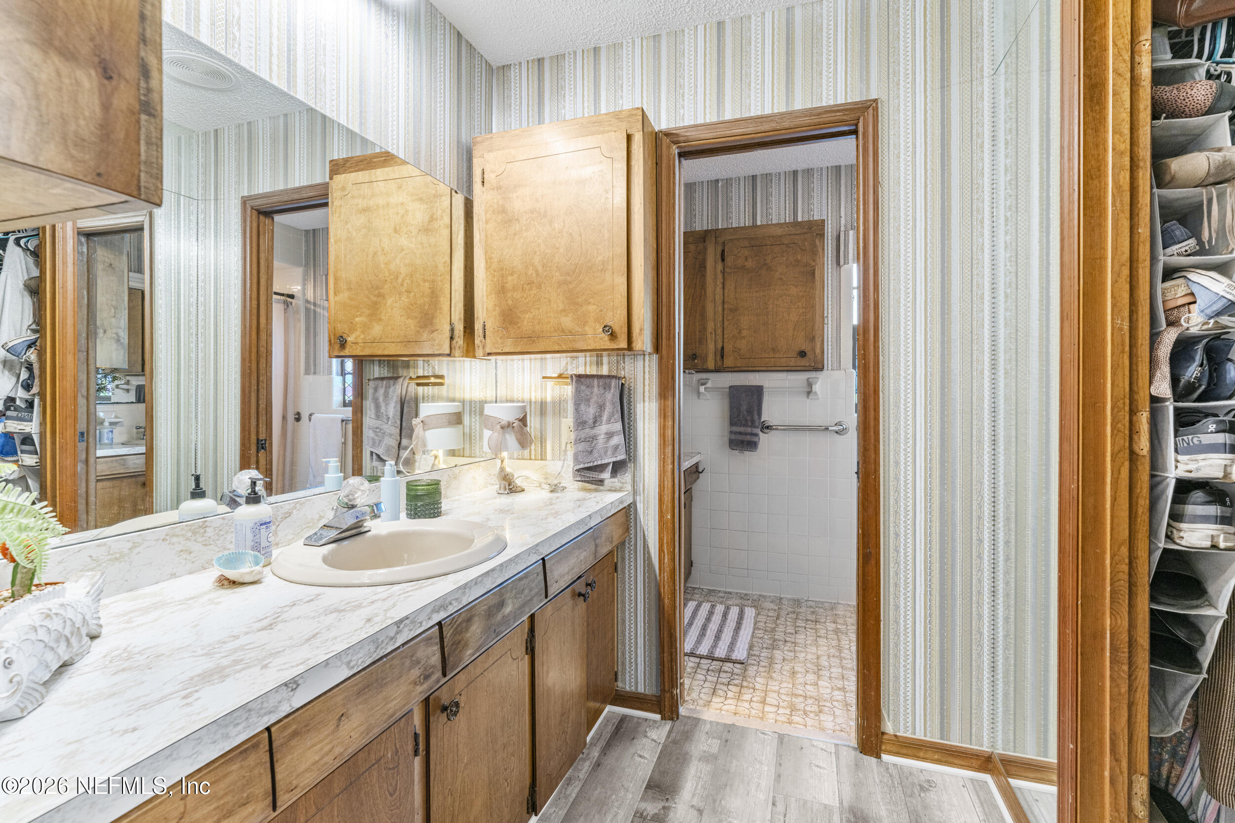 701 16th Street St. Augustine, FL 32080 - Photo 17 of 39 a bathroom with a sink a vanity and a mirror