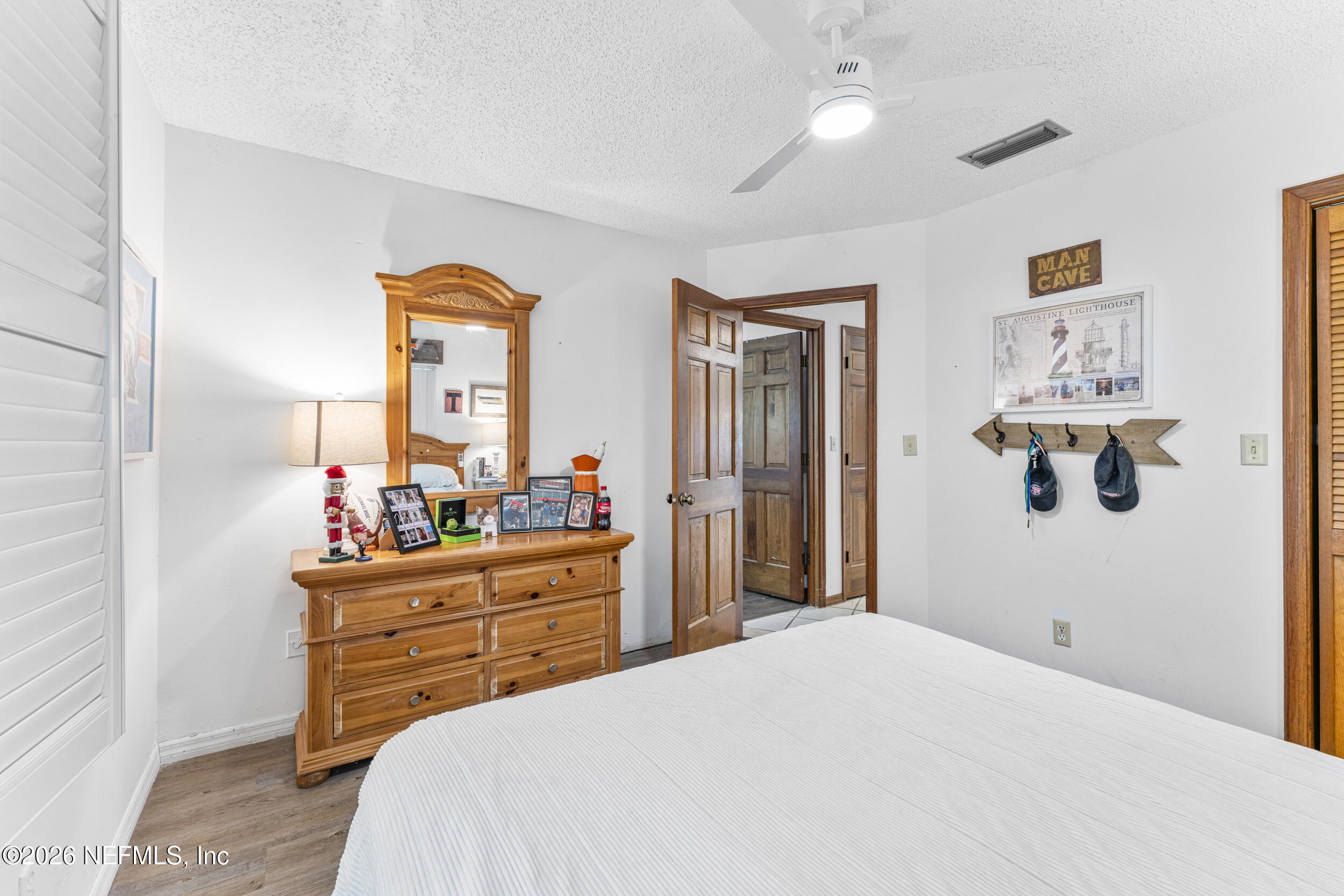 701 16th Street St. Augustine, FL 32080 - Photo 25 of 39 a bedroom with a bed and a dresser
