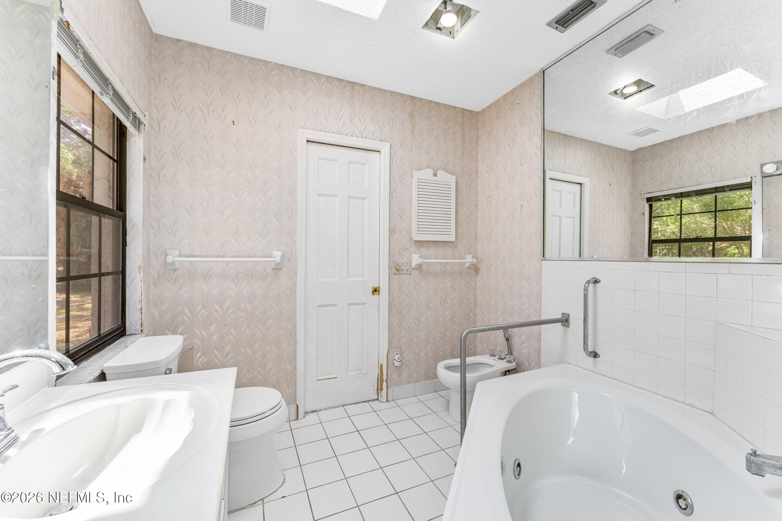 701 16th Street St. Augustine, FL 32080 - Photo 30 of 39 a bathroom with a sink a toilet and tub