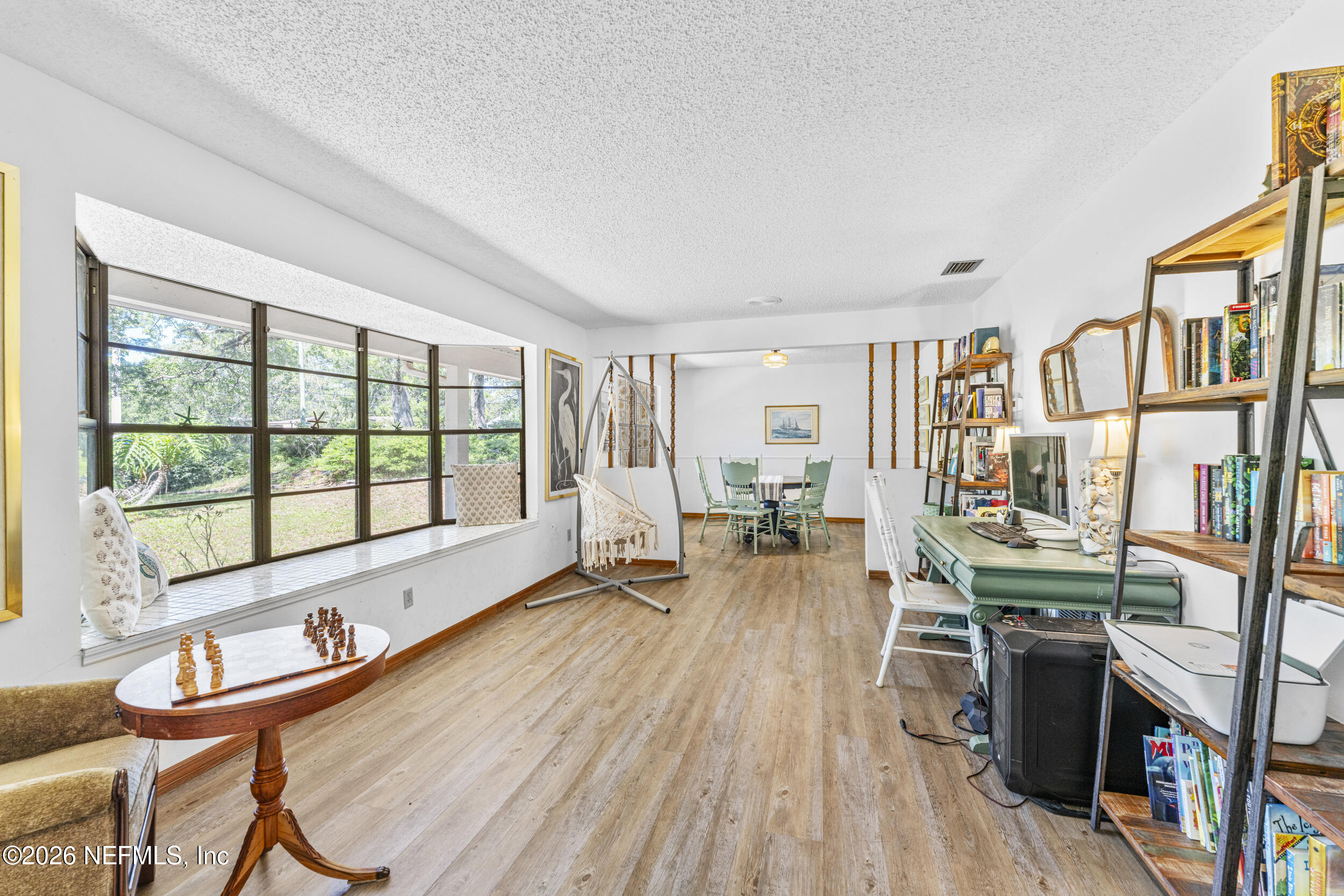 701 16th Street St. Augustine, FL 32080 - Photo 10 of 39 a room with furniture a flat screen tv and a floor to ceiling window