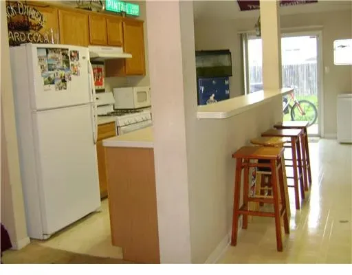 a kitchen with a refrigerator a stove and a window