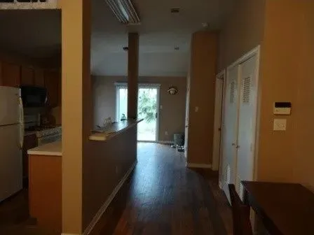 a view of hallway with wooden floor