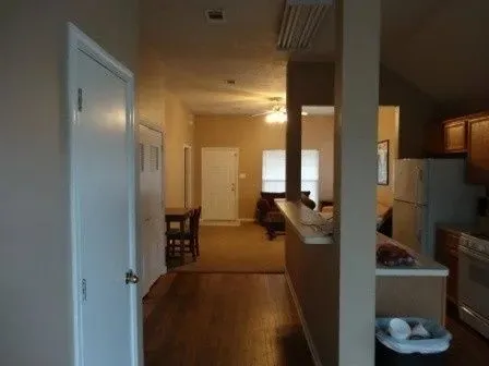 a view of a hallway with furniture and floor to ceiling window