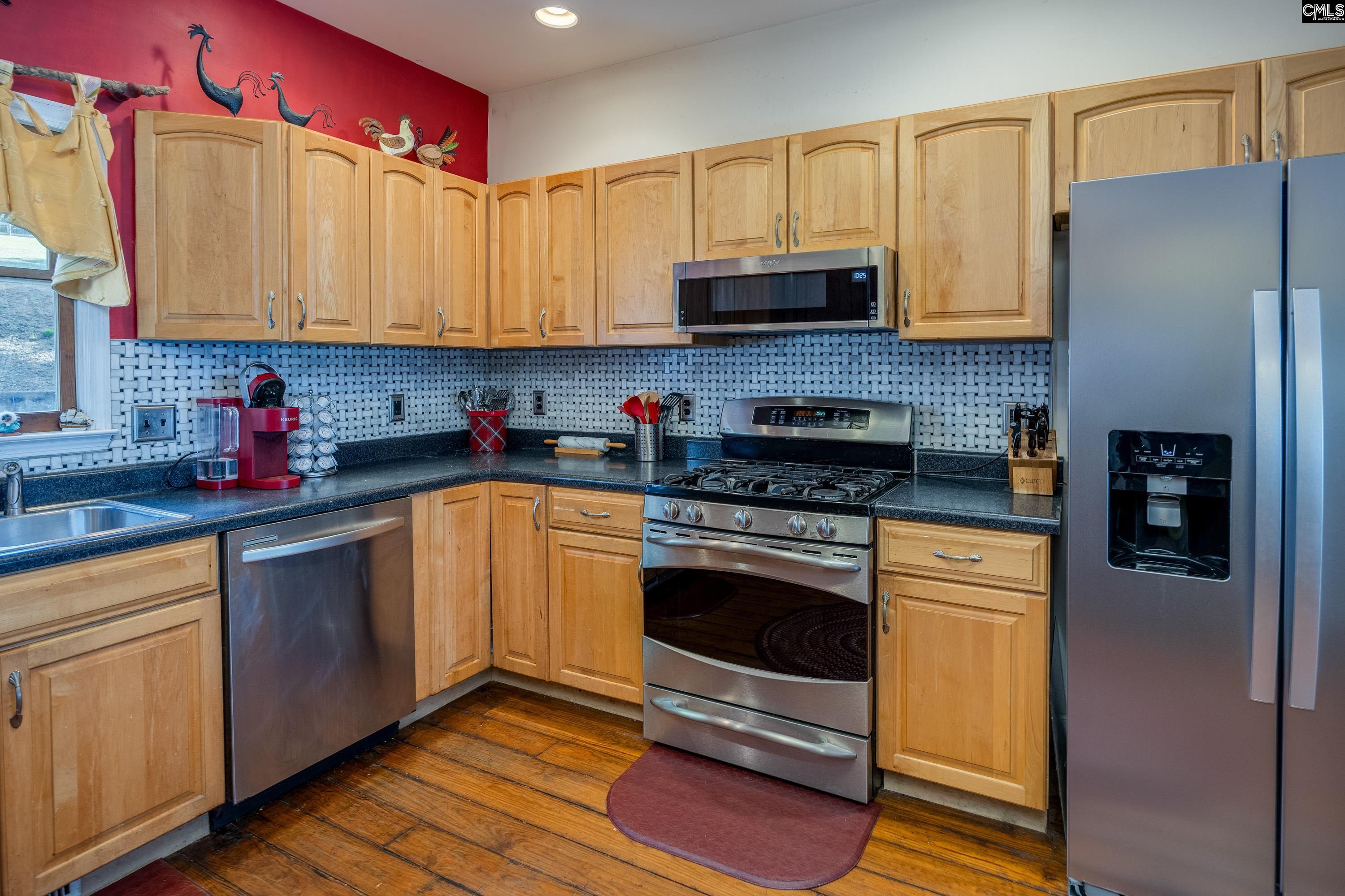 2577 Harbor View Road Camden, SC 29020 - Photo 20 of 42 a kitchen with stainless steel appliances granite countertop a stove a sink and a refrigerator