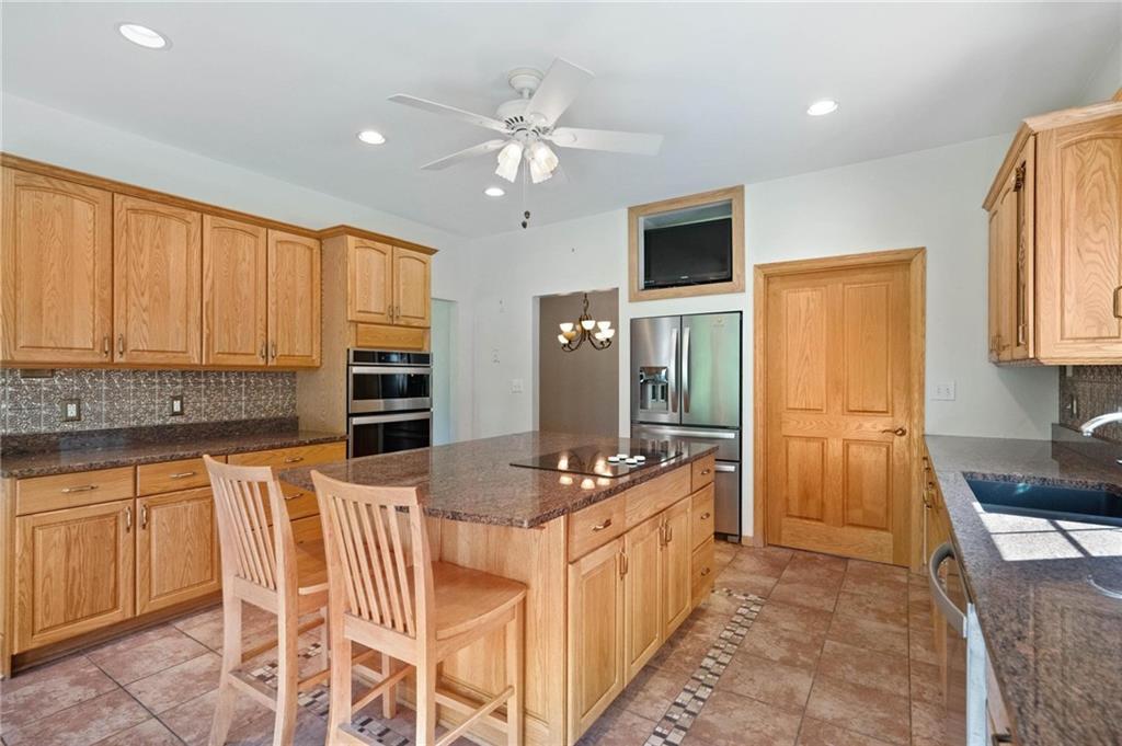 216 Marshall Road Oakdale, PA 15071 - Photo 7 of 25 a kitchen with stainless steel appliances kitchen island granite countertop a sink and cabinets