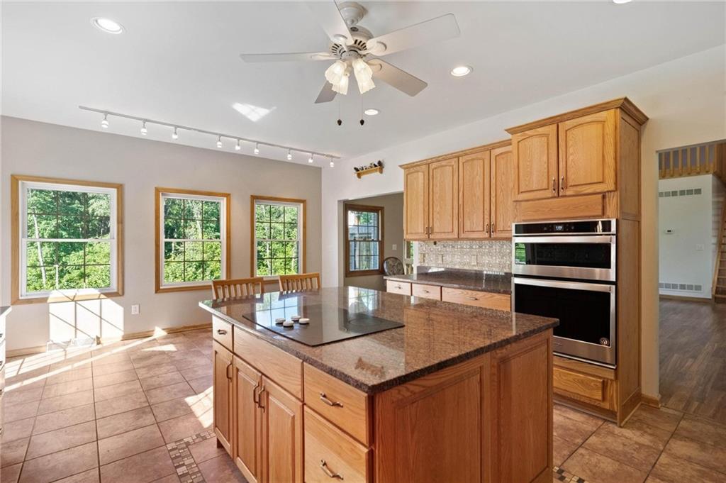 216 Marshall Road Oakdale, PA 15071 - Photo 9 of 25 a kitchen with granite countertop a stove cabinets and refrigerator
