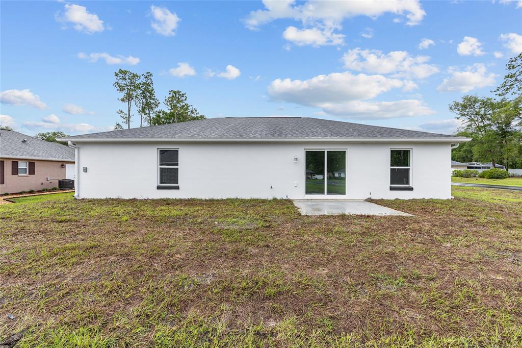 13019 Northeast 7th Loop Silver Springs, FL 34488 - Photo 34 of 35 a view of a house with a backyard