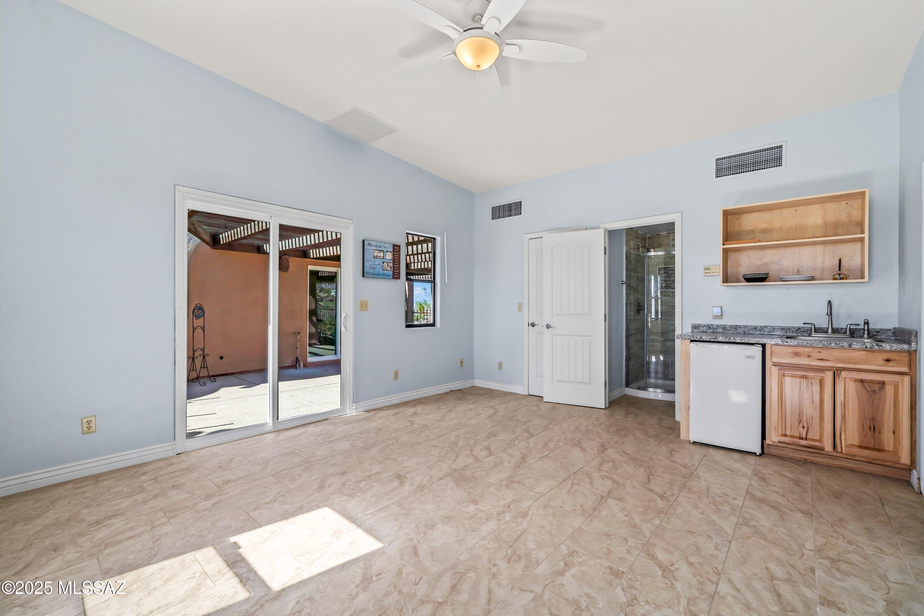 30 West Stone Loop Tucson, AZ 85704 - Photo 21 of 26 a view of an empty room with window and cabinet