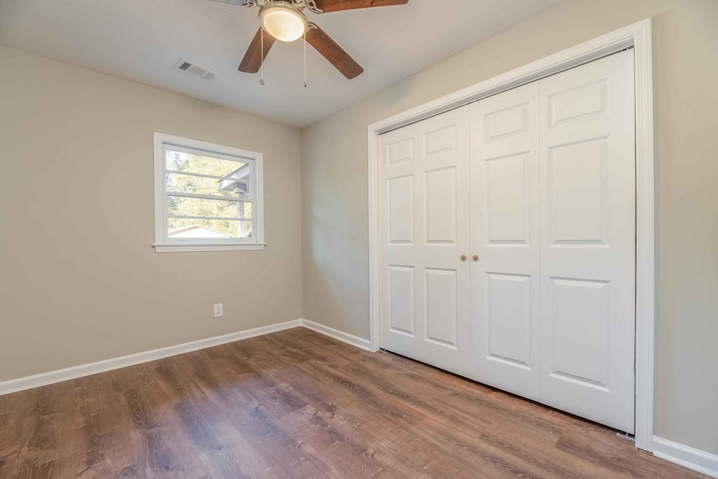 4810 Toney Drive Columbus, GA 31903 - Photo 8 of 17 a view of empty room with wooden floor and fan