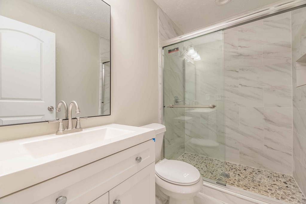 4810 Toney Drive Columbus, GA 31903 - Photo 9 of 17 a bathroom with a sink a toilet and shower