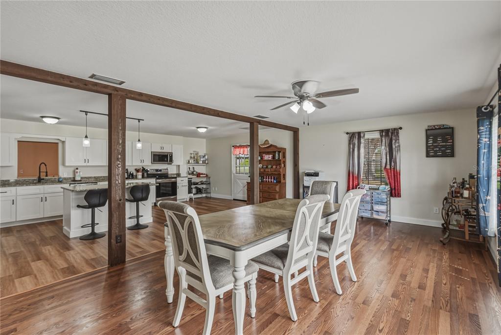 609 West Pipkin Road Lakeland, FL 33813 - Photo 23 of 72 a view of a dining room with furniture and wooden floor