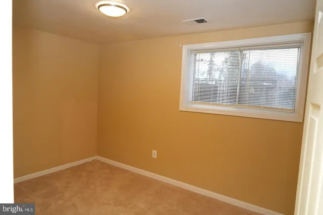a view of an empty room and closet area