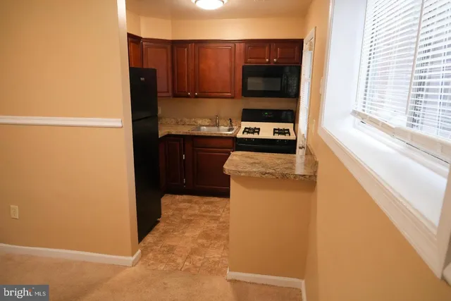 a kitchen with a refrigerator and a stove