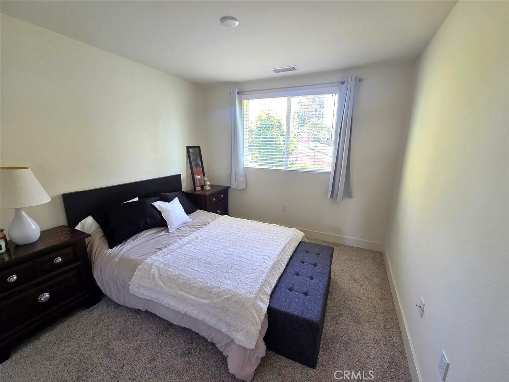 6741 Rhea Court Reseda, CA 91335 - Photo 13 of 18 a bedroom with a bed and window
