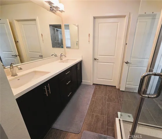 a bathroom with a double vanity sink a and mirror