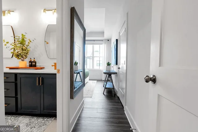 a view of a hallway with wooden floor and entryway
