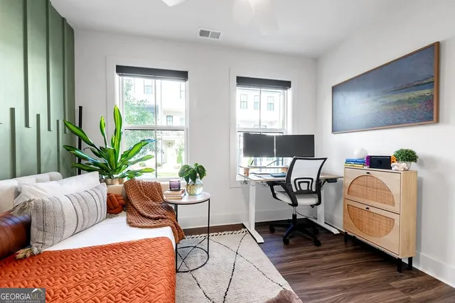 a living room with furniture potted plant and a window