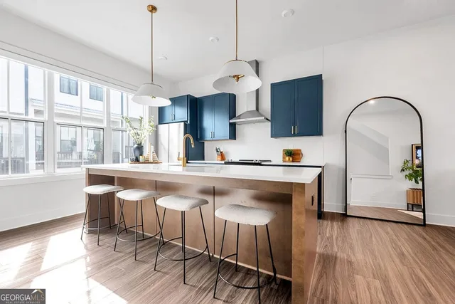 a kitchen with a table chairs in it and wooden floors