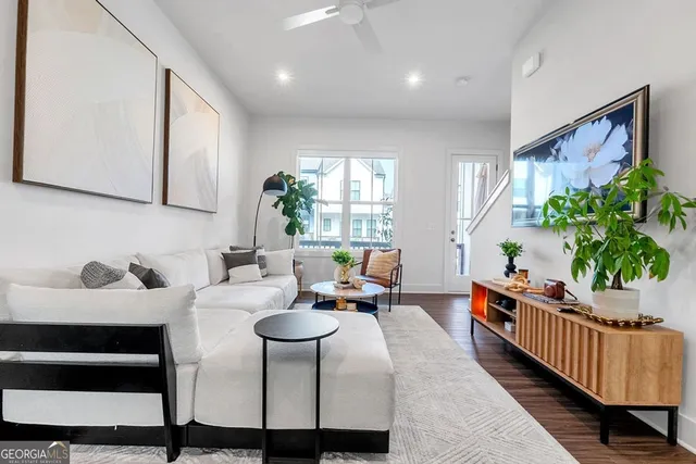 a living room with furniture and a potted plant