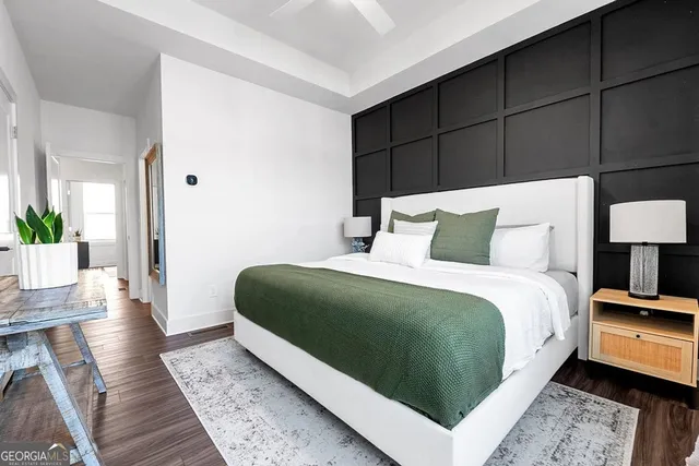 a bedroom with a bed lamp and a rug