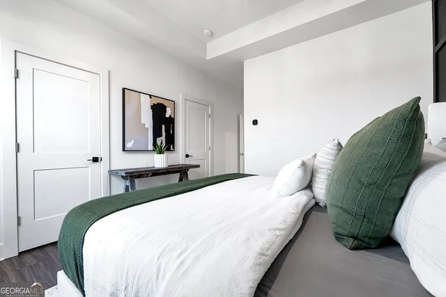 a bedroom with a bed and a mirror