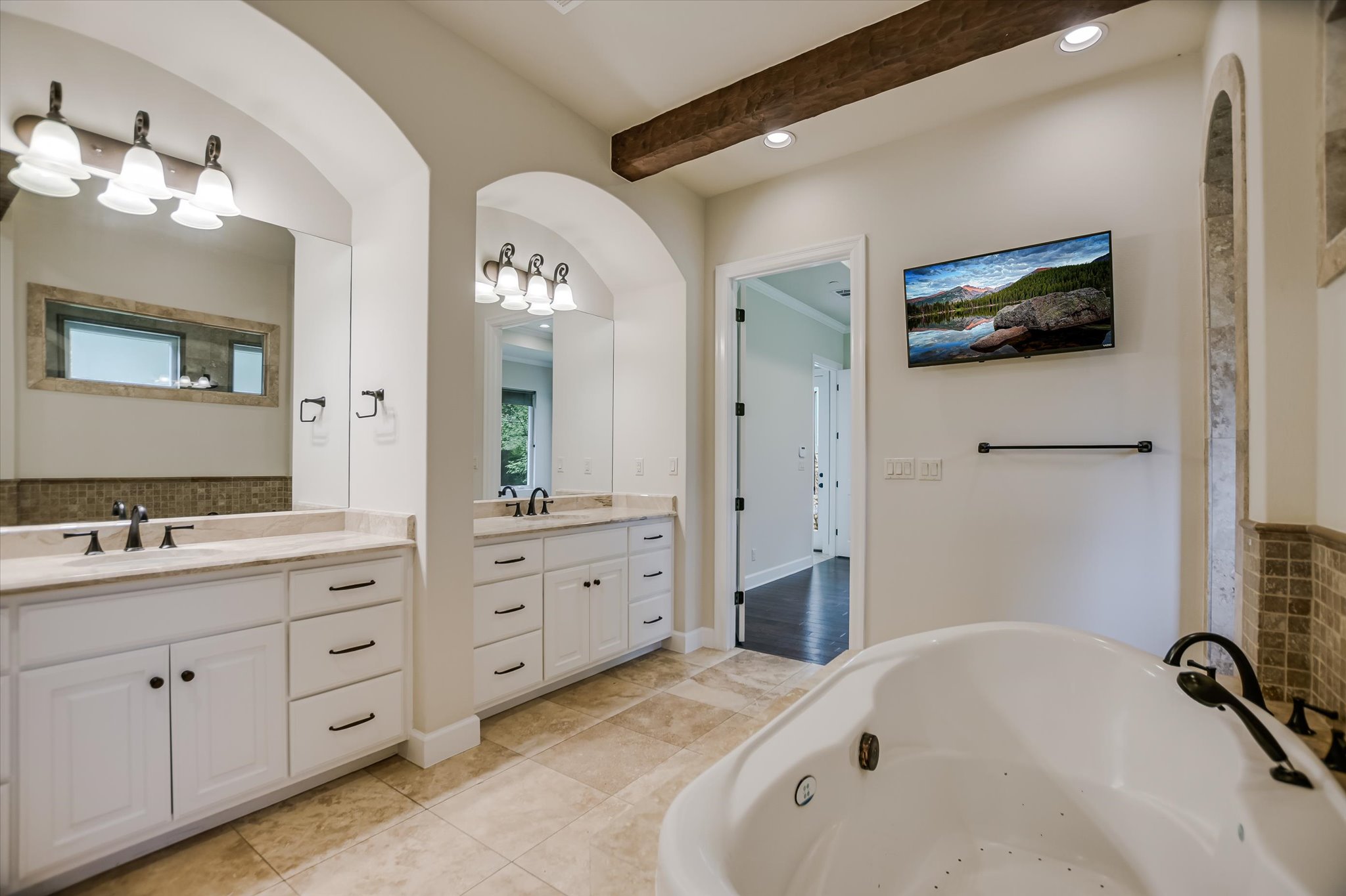 11 Inwood Circle Austin, TX 78746 - Photo 19 of 38 Indulge in relaxation with this spa-like primary bathroom featuring dual vanities and a deep soaking tub and Marble counters.