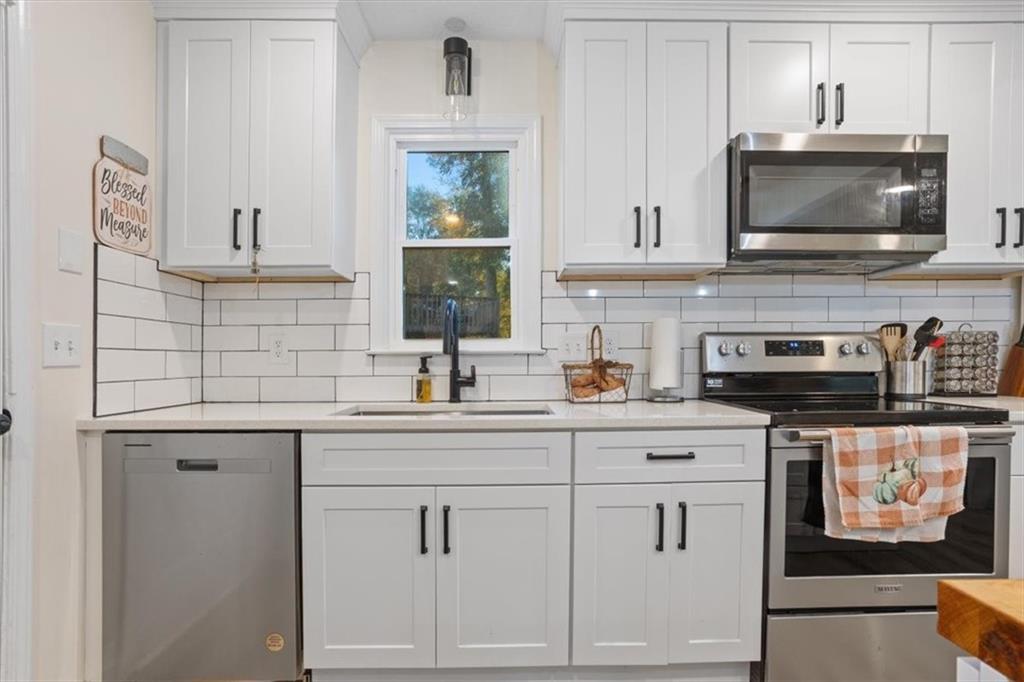 58 Quail Run Cartersville, GA 30120 - Photo 12 of 44 a kitchen with stainless steel appliances white cabinets and a sink