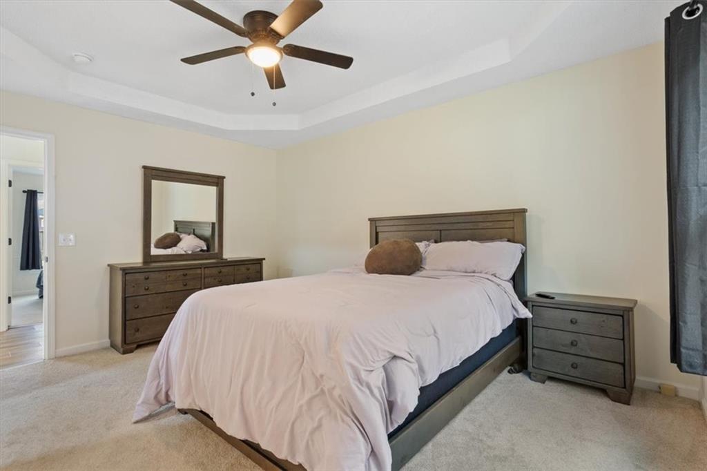 58 Quail Run Cartersville, GA 30120 - Photo 16 of 44 a bedroom with a bed and a chandelier