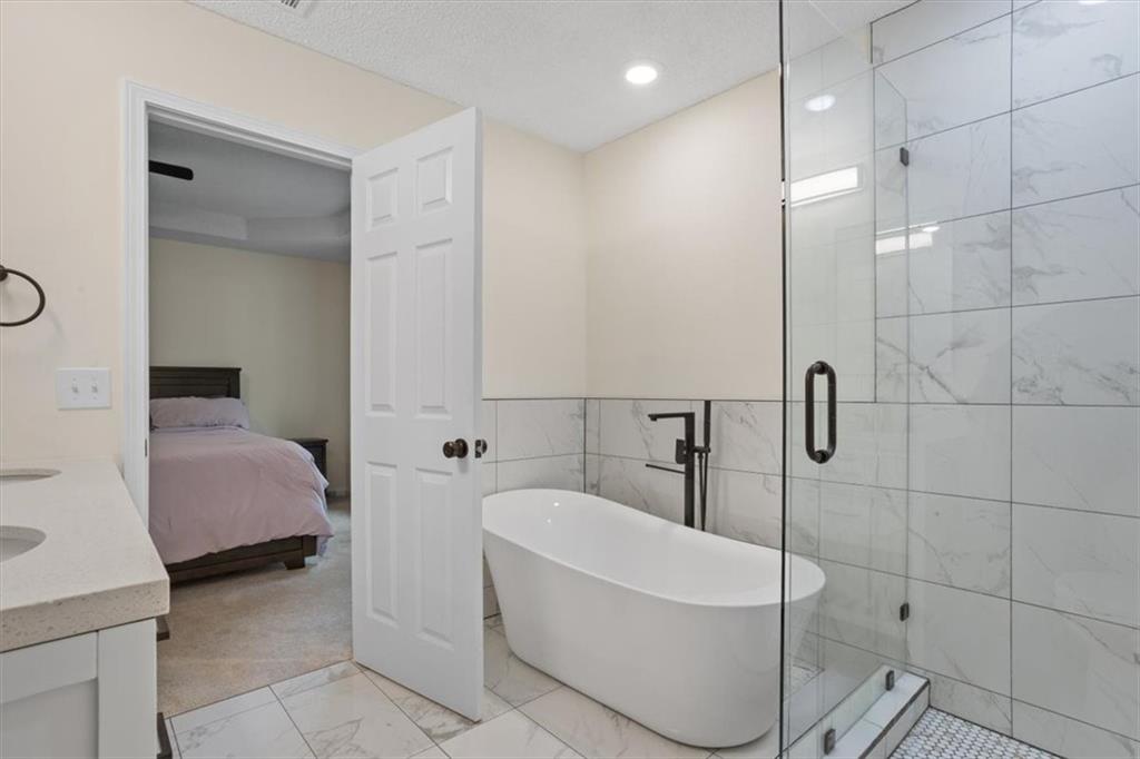 58 Quail Run Cartersville, GA 30120 - Photo 18 of 44 a bathroom with a bathtub and a shower