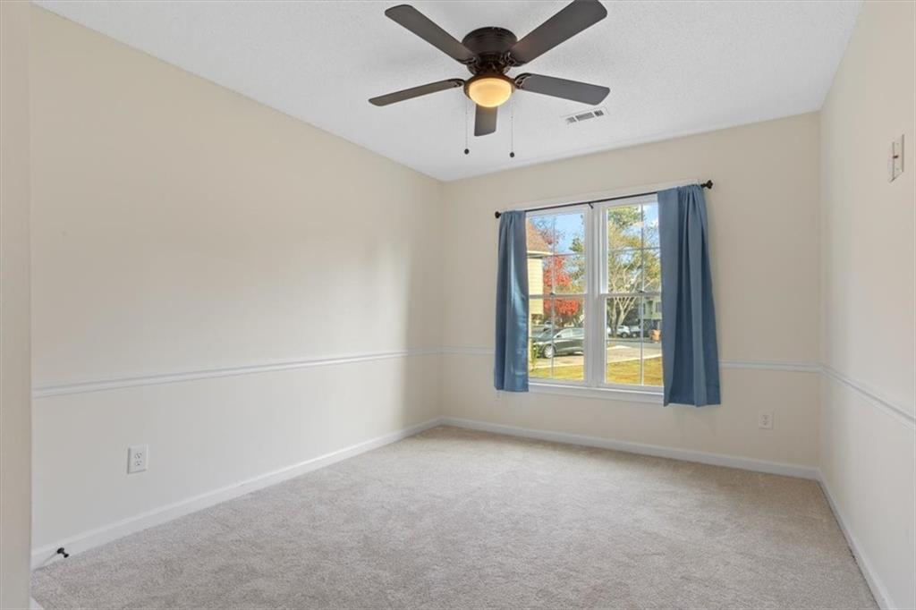 58 Quail Run Cartersville, GA 30120 - Photo 22 of 44 an empty room with a window and a ceiling fan
