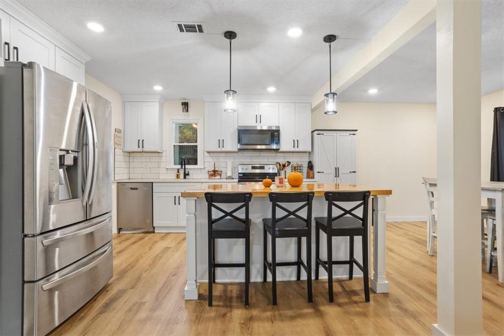58 Quail Run Cartersville, GA 30120 - Photo 8 of 44 a kitchen with stainless steel appliances a dining table chairs refrigerator and microwave