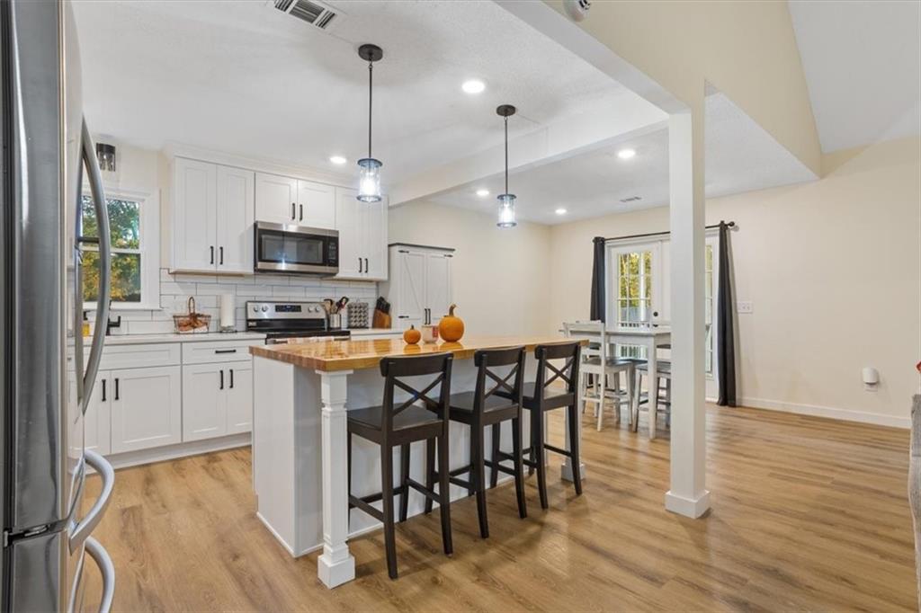 58 Quail Run Cartersville, GA 30120 - Photo 10 of 44 a kitchen with kitchen island granite countertop a sink cabinets and wooden floor