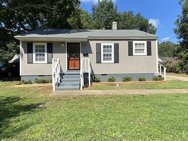 a front view of a house with a yard