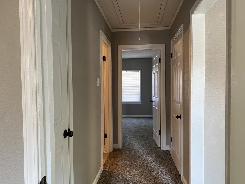 2119 Pendleton Street Memphis, TN 38114 - Photo 4 of 8 a view of a hallway with a wooden door