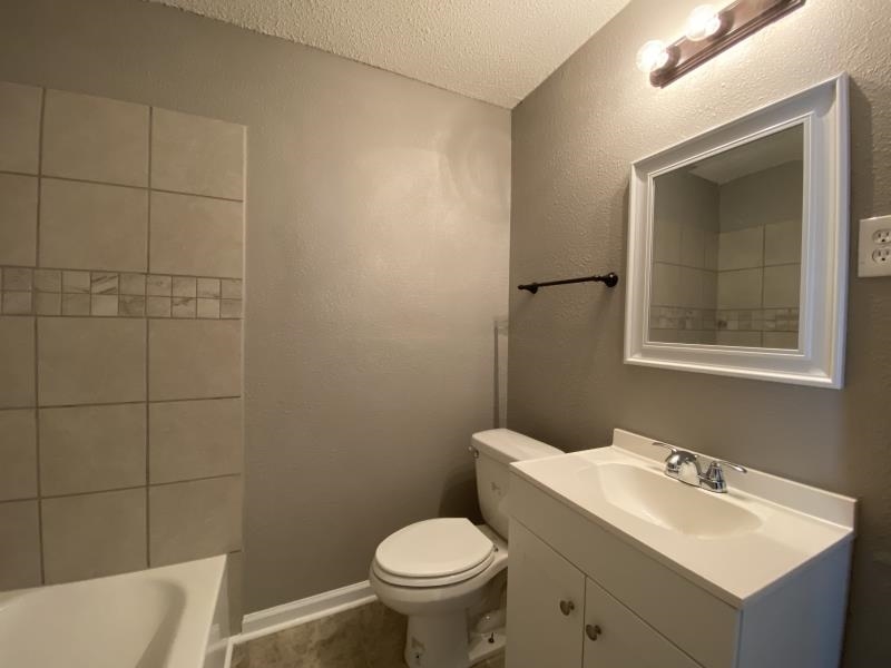 2119 Pendleton Street Memphis, TN 38114 - Photo 7 of 8 a bathroom with a toilet sink and mirror